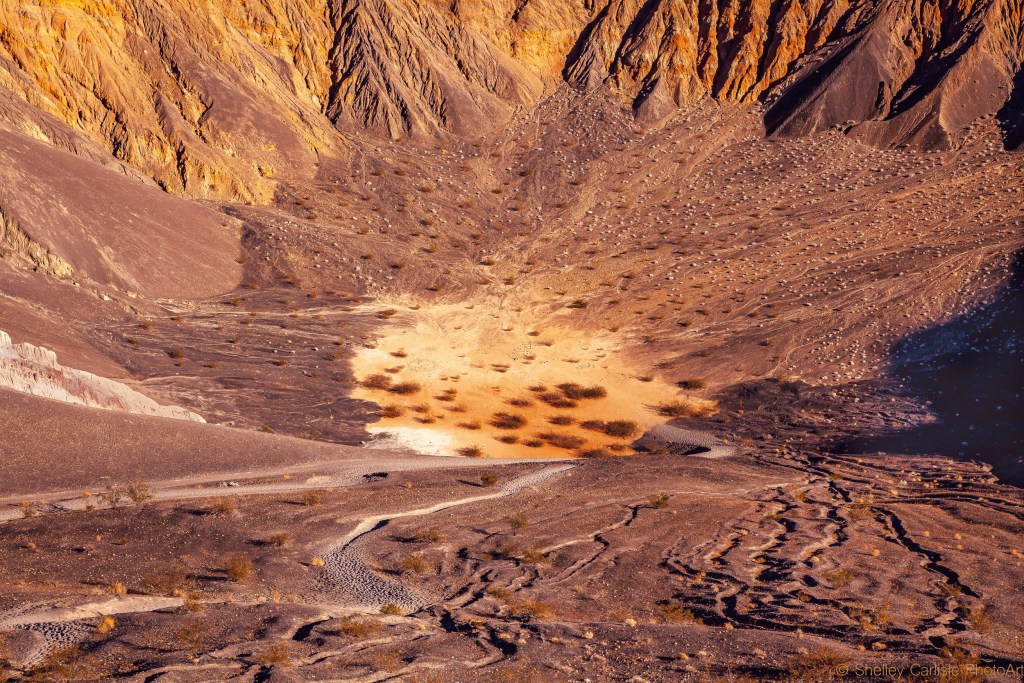Ubehebe crater is a basket of cinders with browns, dark reds, yellows and oranges. Death Valley National Park California