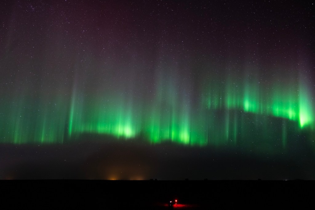 Iceland aurora borealis green lights rise like sharp columns in the sky
