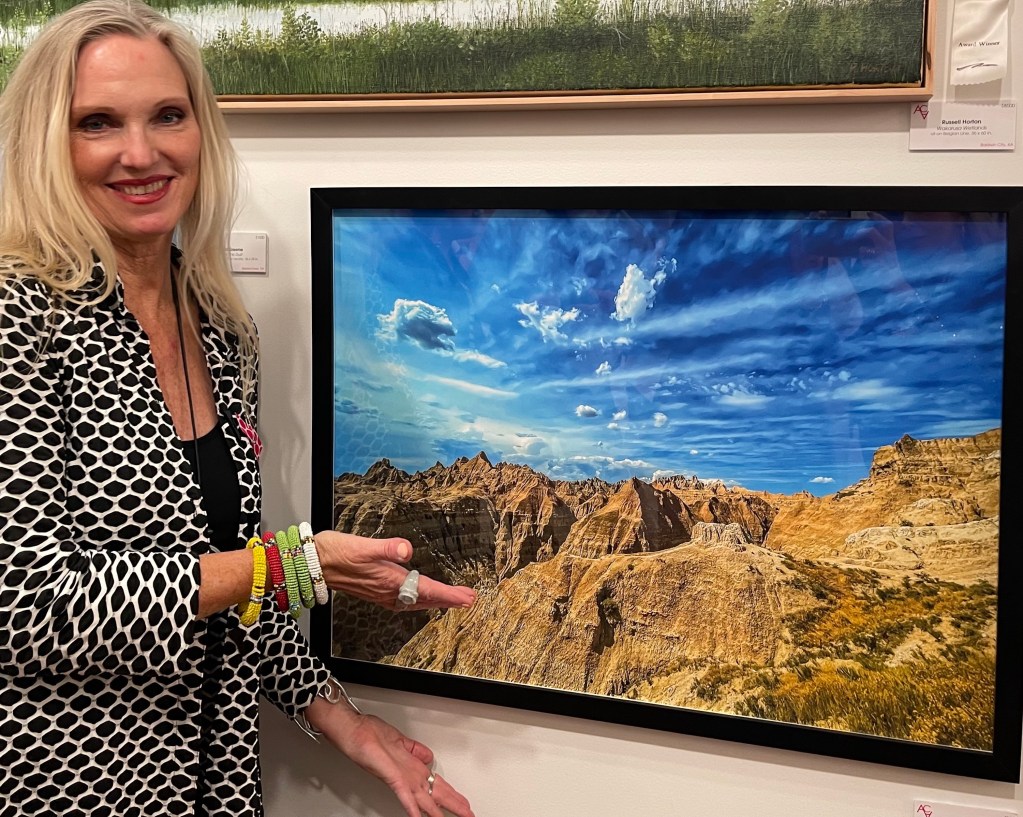 Me with my work "Badland" photograph taken in Bdlands National Park South Dakota. Photo taken at ADC Fine Art's ACA opening celebration November 2021