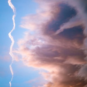 Dramatic storm clouds overhead in Great Basin National Park reaching for a plane contrail that barely escapes