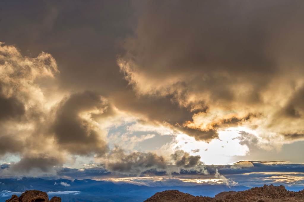 Swirling sunrise clouds create a dragon creature and it's firebreath over the Alabama Hills in souther California