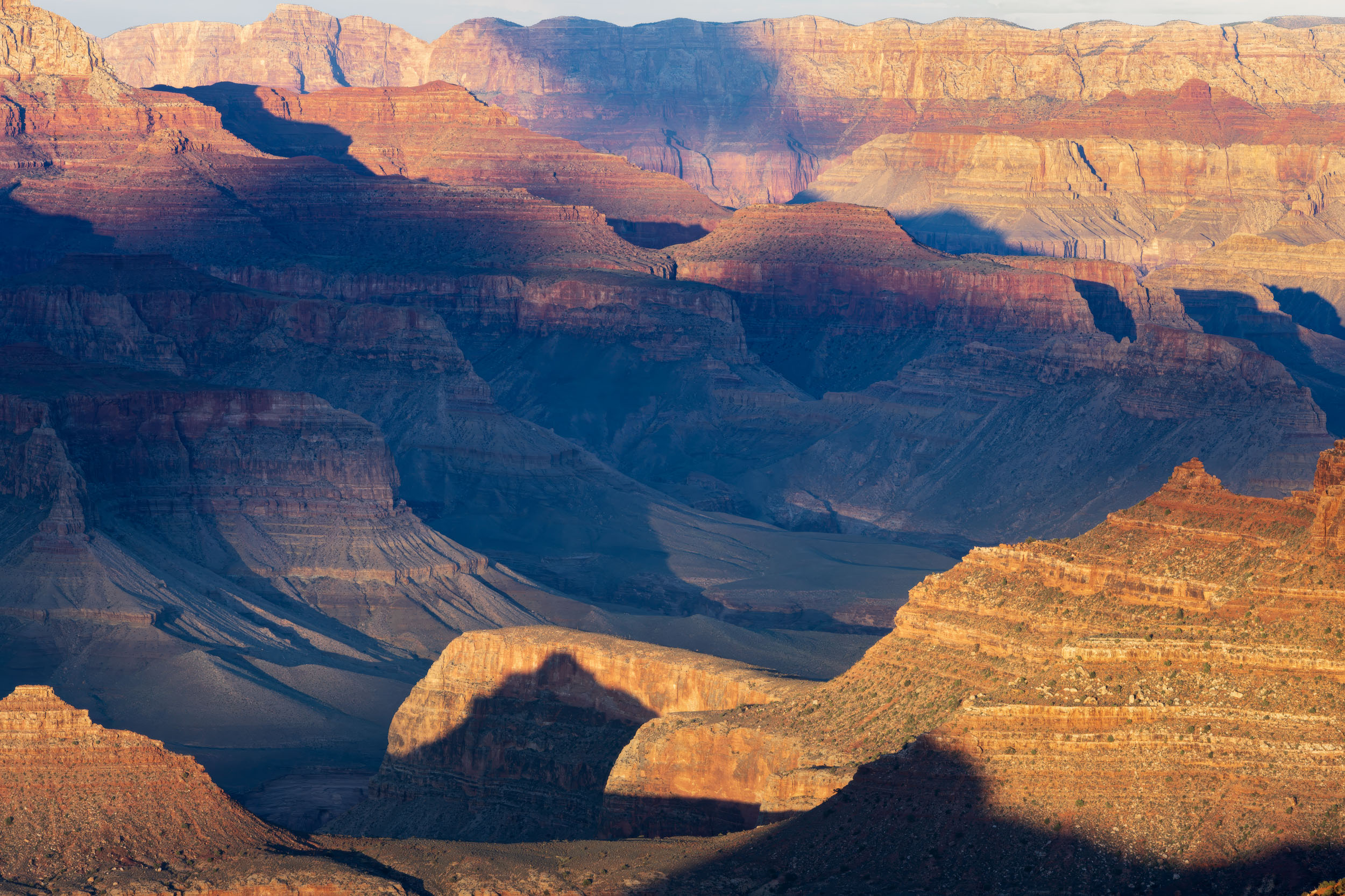 The Grand Canyon sunsets never disappoint, bathing this magnificent geological wonder in orange, yellow, red soft light and dark shadows.