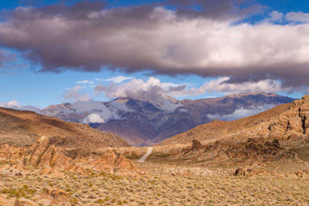 This lonely road meandering through the gorgeous rock and sage landscape of the Alabama Hills in Lone Pine, CA invite one to wander toward the distant mountains and through the clouds.